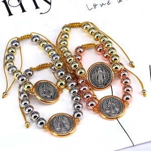 Detail of St. Benedict woven bracelet with gold, silver and rose gold hollow copper beads