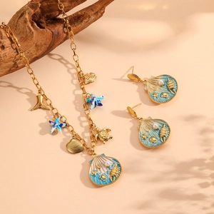 Golden starfish and turtle ocean jewelry set with blue enamel shell pendants