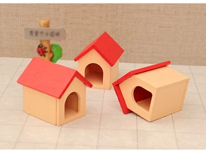 Detailed view of three miniature wooden Christmas dollhouse cottages with red roofs