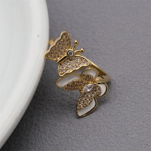 Macro shot of double butterfly open ring with sparkling cubic zirconia and enamel details