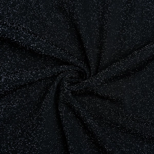 Macro shot of shimmering black metallic fabric texture with elegant pleated swirl details