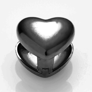 Detailed close-up of a silver mirror-polished heart-shaped locket with opening hinge