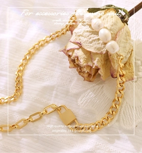 Detail of 18k gold plated surgical titanium steel necklace with pearls and lock charm