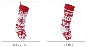 Detail of red and white knit Christmas stockings with reindeer and snowflake patterns