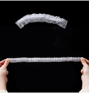 Elastic disposable white PE shower cap showing strong stretch and flexible extension