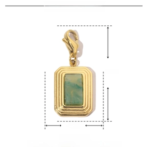 Detailed view of gold stainless steel rectangle pendant with green natural stone inlay
