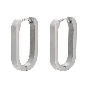 Detailed macro view of U-shaped silver stainless steel earrings with matte finish