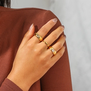 Detailed view of three 18K gold plated stainless steel rings set with zircon stones