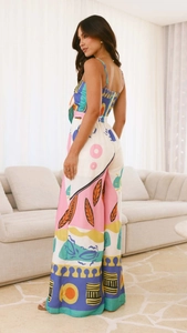 Detail view of colorful print jumpsuit showing wide-leg cut and vibrant fabric texture