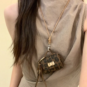 Chic leopard print mini bag pendant necklace with a metal clasp and woven rope