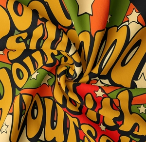 Macro detail of Bohemian tapestry fabric showing vibrant spiral texture and Power letters
