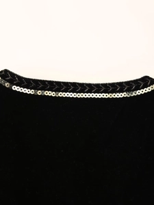 Close-up of velvet vest collar with silver sequins and ethnic embroidery detail