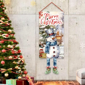 Festive Merry Christmas snowman door banner hanging next to a decorated tree