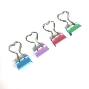 Colorful macaron heart-shaped metal binder clips in pastel pink, blue, green and purple