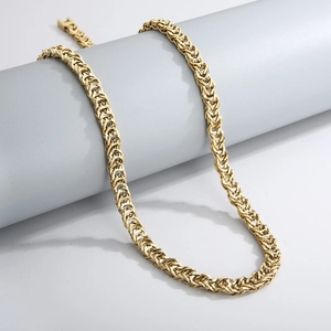 Detailed close-up of golden Byzantine chain necklace on a cylindrical display