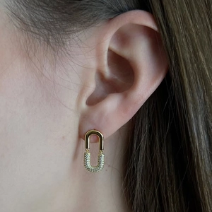Elegant gold U-shape link earrings with white zircon pavé setting on a female model