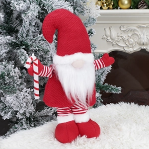 Christmas gnome doll with long red hat and white beard in a cozy holiday living room