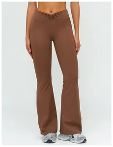 Close-up of brown high-waisted yoga pants featuring V-shaped smocked waist and flare leg