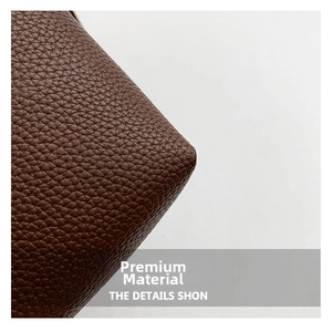Close-up of brown litchi pattern leather texture and fine stitching on bucket bag