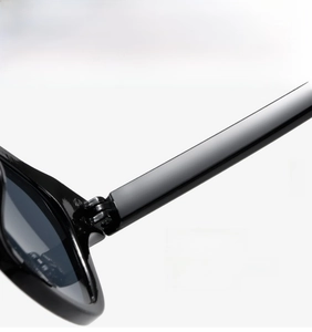 Detailed close-up of a durable metal hinge on these premium black fashion sunglasses