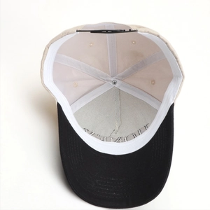 Detail of adjustable snapback closure and inner sweatband of color-block baseball cap