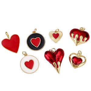 Detailed set of 7 gold-plated heart pendants with red enamel and diverse textures