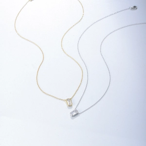Close-up of geometric square zircon pendants in gold and silver finish on delicate chains