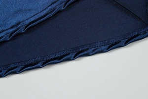 Detail of premium navy blue satin fabric showing precise stitching and hemline finish