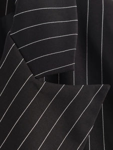 Close-up of lapel on a black pinstripe blazer showing premium twill fabric texture