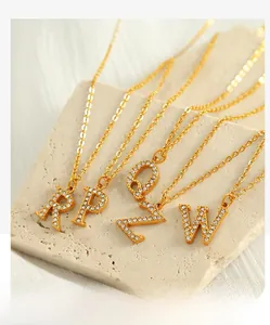 Detail of gold titanium steel alphabet necklaces with micro-pave cubic zirconia crystals