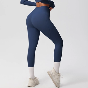 Detail of high waisted navy blue yoga pants featuring side pocket and athletic fit