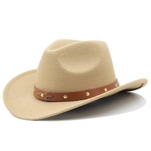 Close-up of beige felt cowboy hat featuring a brown leather band with gold rivets