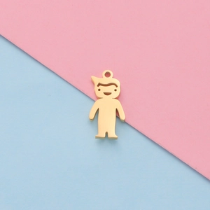Close-up of a gold stylized boy charm pendant for DIY jewelry on a two-tone background