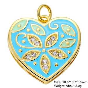 Macro view of gold heart pendant with light blue enamel and sparkling cubic zirconia