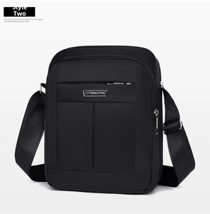 Detail of waterproof oxford fabric and metal brand logo on the men shoulder bag