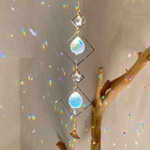 Macro shot of sun catcher with crystal prisms casting colorful rainbow reflections on the wall