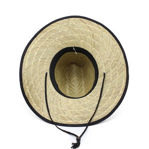 Natural straw sun hat with 11.5cm wide brim and black trim featuring a windproof chin strap