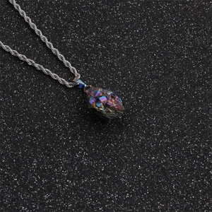 Close-up of irregular rainbow amethyst pendant on a silver twisted chain necklace