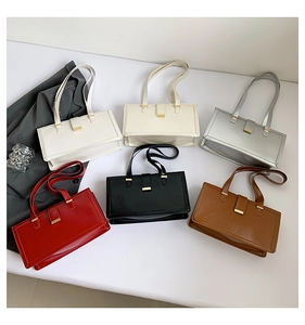 Flat lay showing six colorful large retro shoulder bags with metallic buckle details