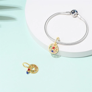 Detailed view of silver snake chain bracelet with artistic colorful gemstone pendant
