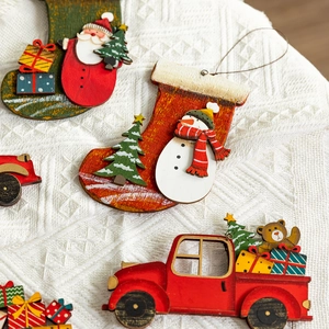 Christmas painted wooden pendants with Santa socks and red truck on white knit background