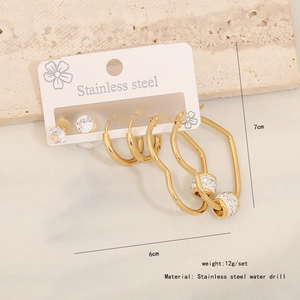 Close-up of golden stainless steel rhinestone heart earrings and size details