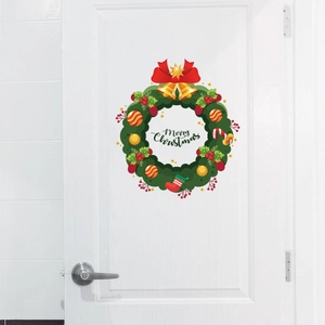 Christmas wreath door sticker with bells and Merry Christmas text on a white wooden door