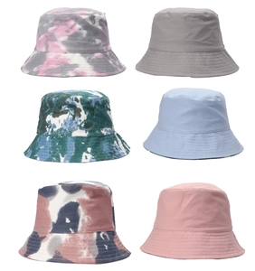 Collection of six cotton bucket hats in tie-dye patterns and solid colors on white background