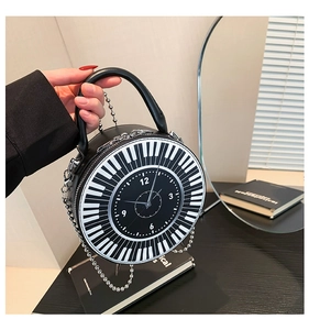 Close-up of circular handbag featuring piano key edges and a clock dial face design