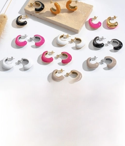 Detailed view of colorful C-shaped titanium steel earrings in multiple vibrant colors