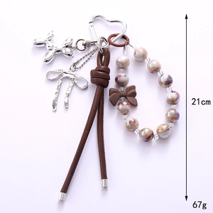 Silver balloon dog keychain with brown bow beads and heart metal clasp, length 21cm