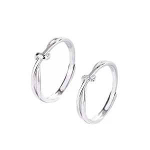 Adjustable S925 silver Mobius knot rings with small diamond inlay on white background