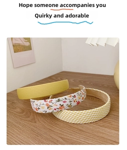 Detailed set of floral, plaid, and yellow fabric headbands on a wooden desk