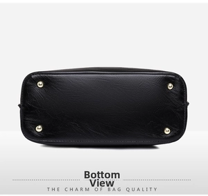 Detail view of the black PU leather bag bottom with four gold protective metal feet